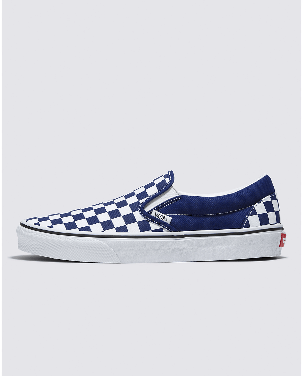 Side view of blue slip-on sneakers with white checkerboard panels