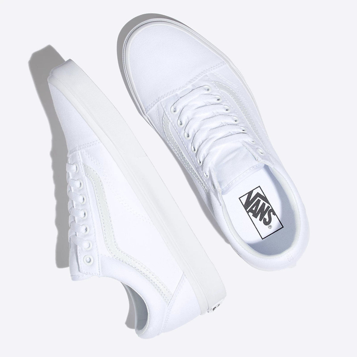 White lace-up sneakers with Vans logo tongue and stripe detail