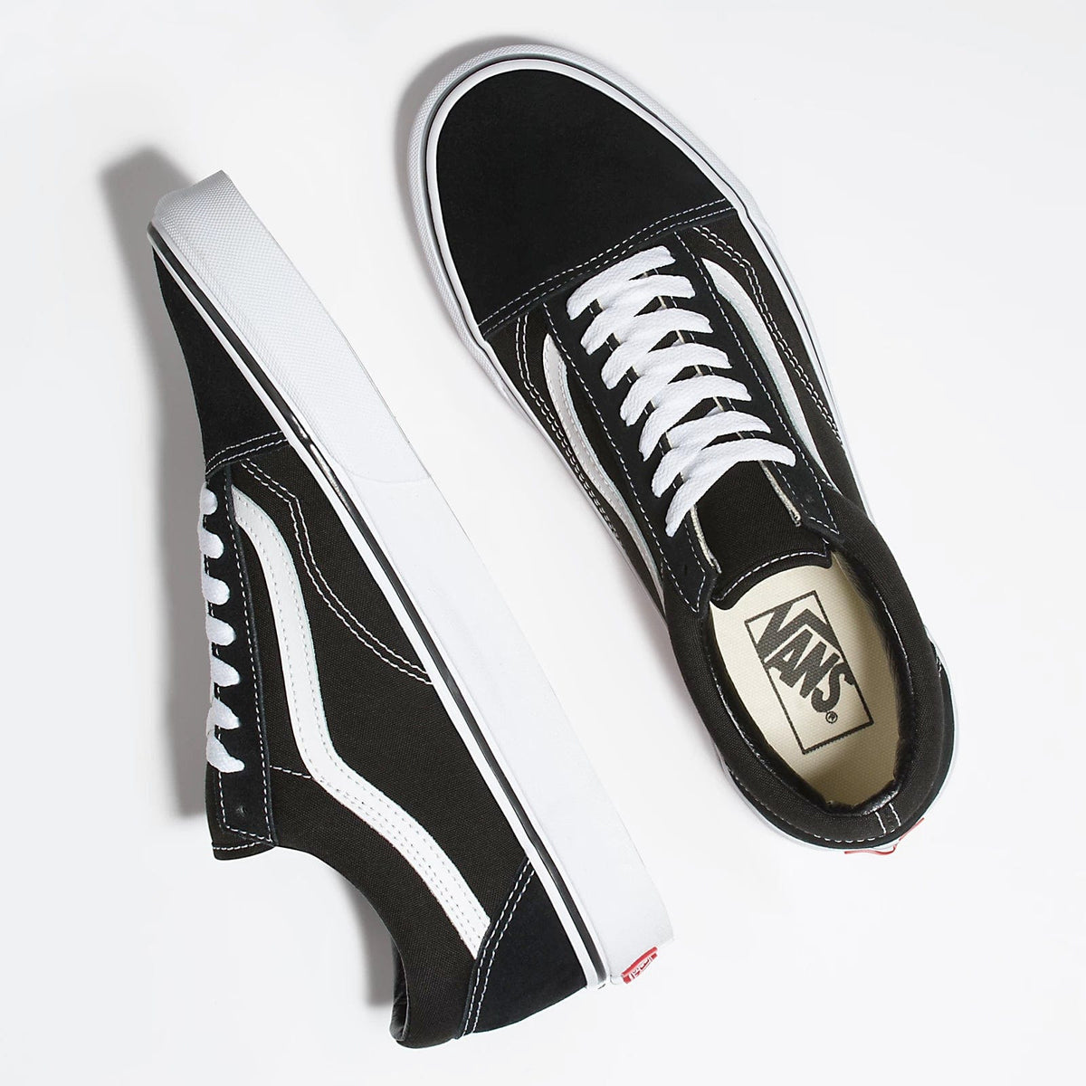 Black low-top sneakers with white side stripe, lace-up design, and Vans logo label