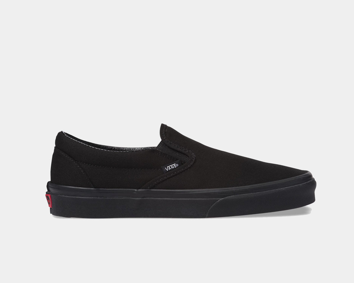 Black slip-on canvas sneakers with padded collar and white rubber sole