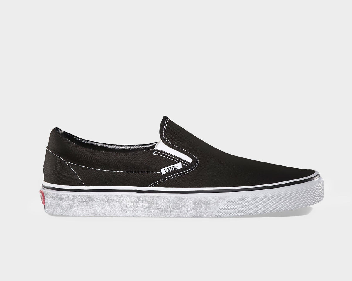 Black canvas slip-on sneaker with white vulcanized sole and side stripe stitching