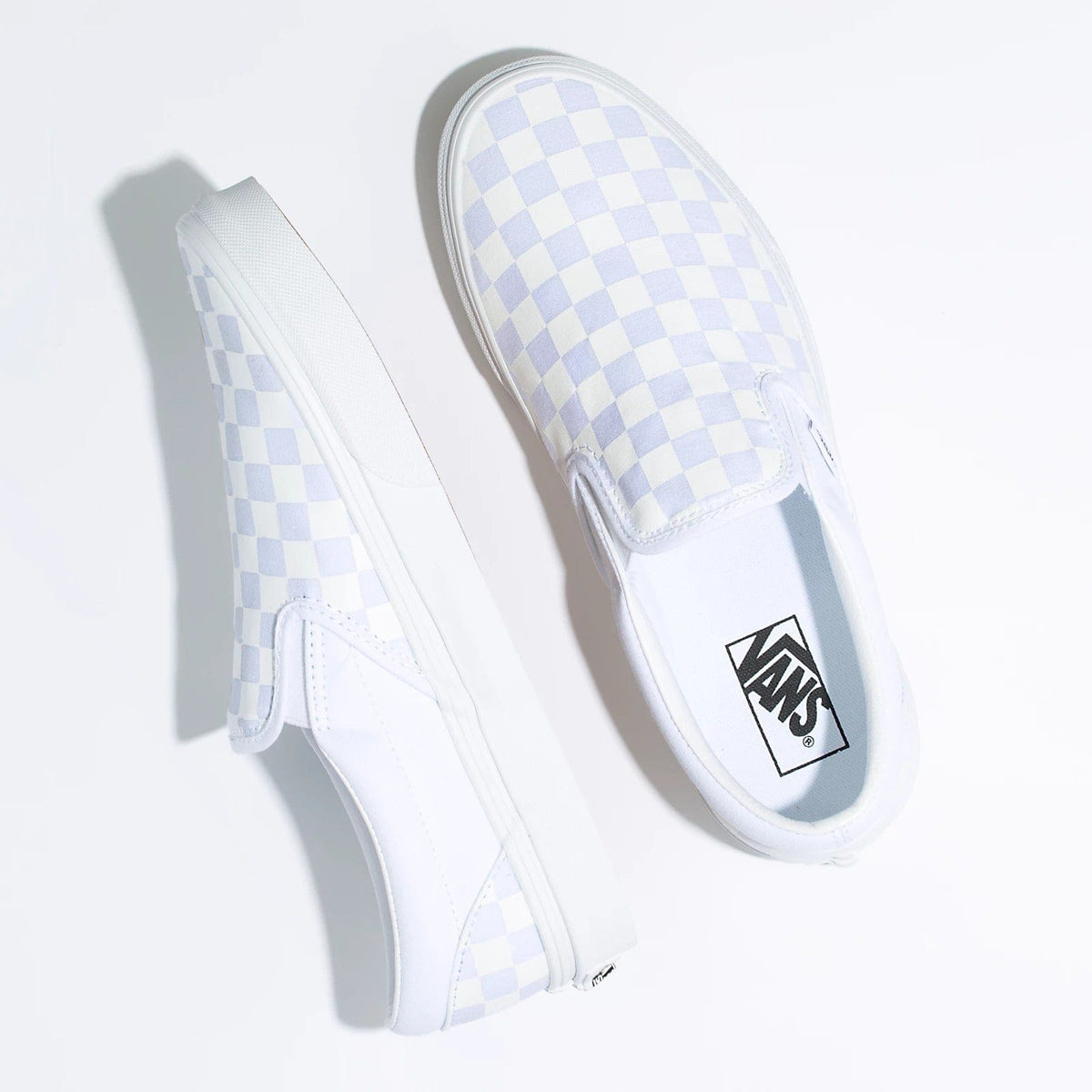 White and light blue checkerboard Vans slip-on sneakers with sidewall logo patch