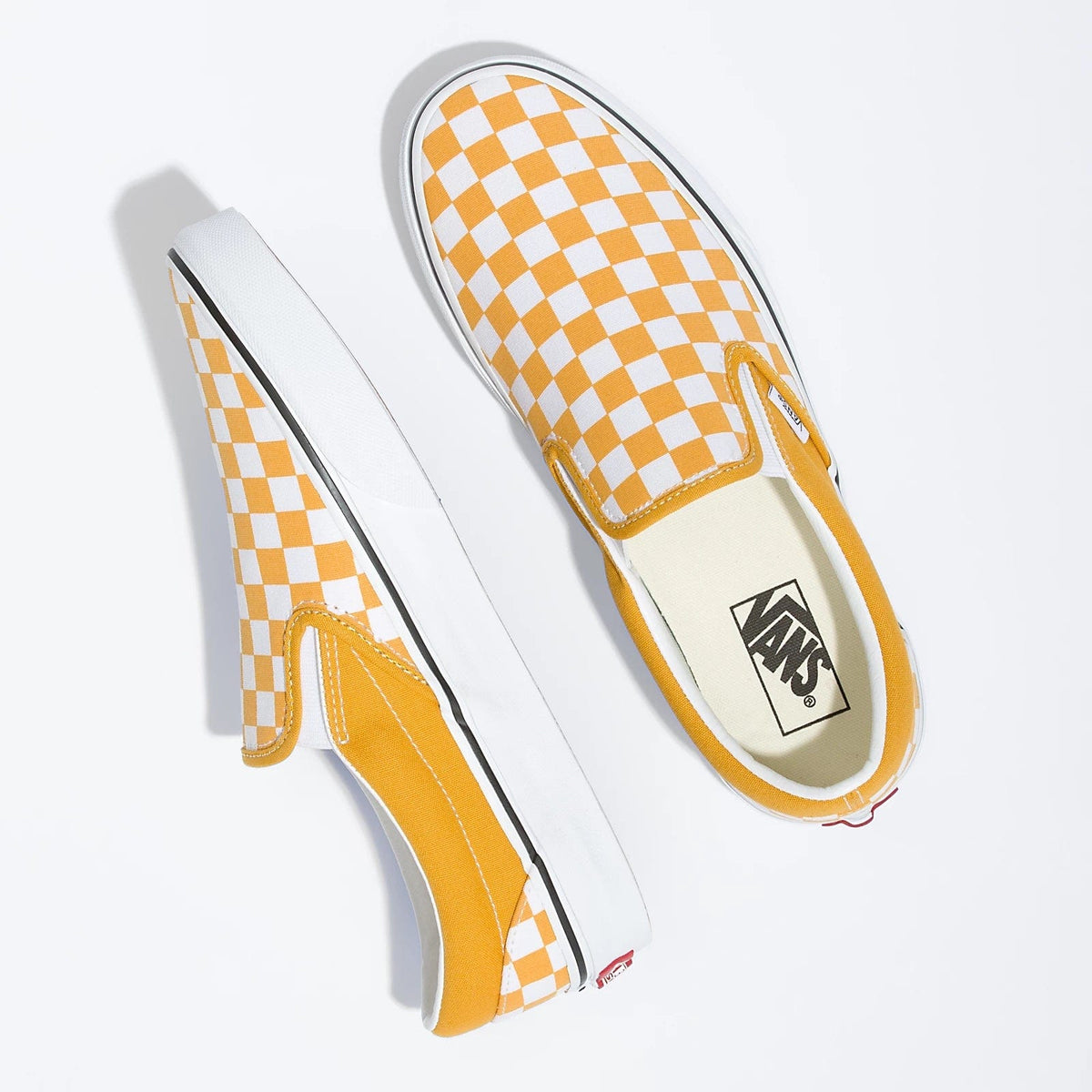 Checkerboard slip-on shoes, side view, orange-and-white checks, Vans logo on insole.