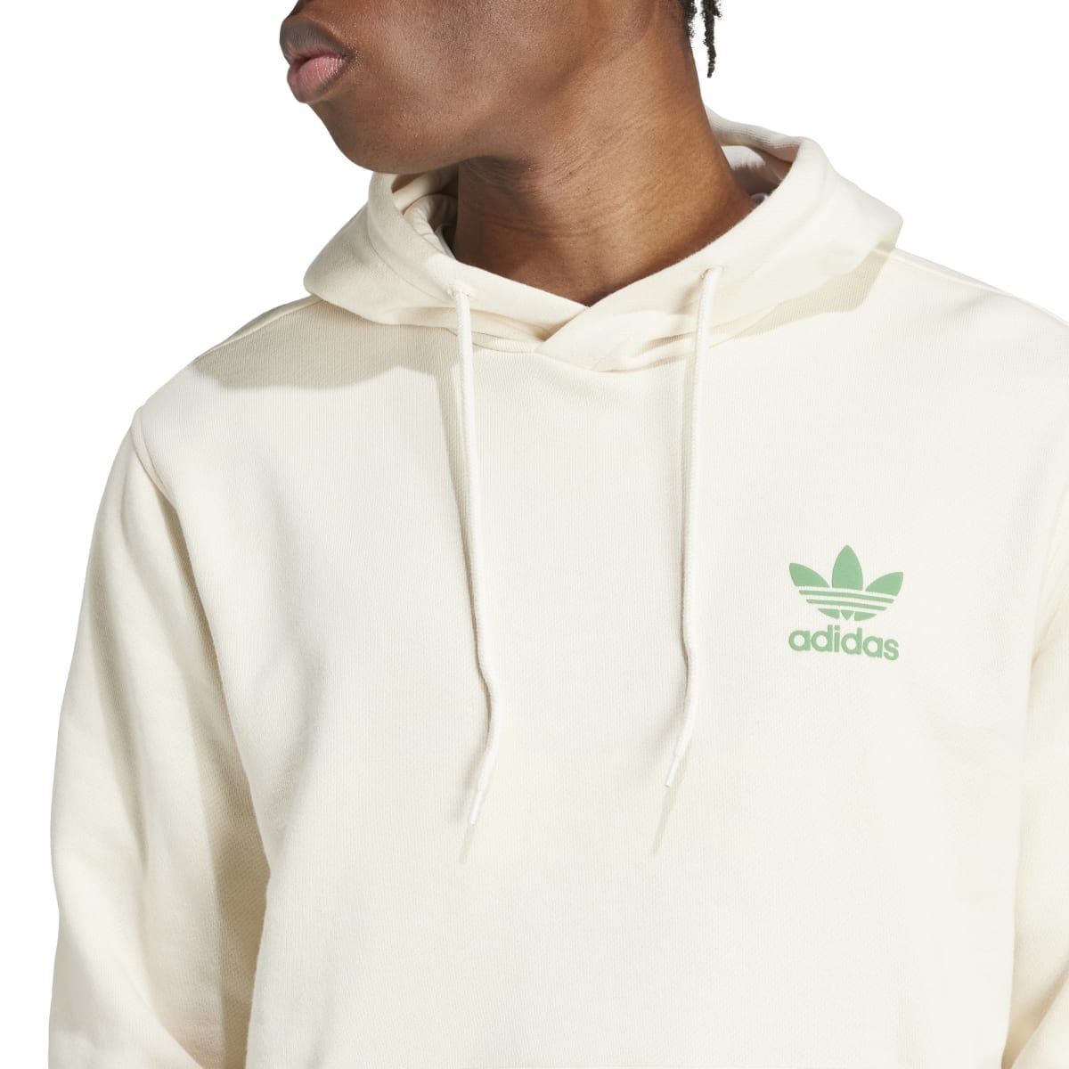 Cream adidas hoodie close-up with trefoil graphic and drawstring hood
