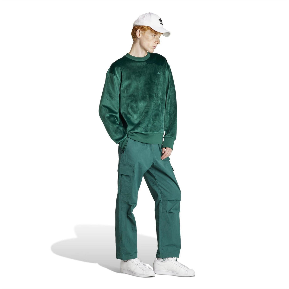 Green relaxed-fit long sleeve sweater with crew neck and ribbed cuffs, side view