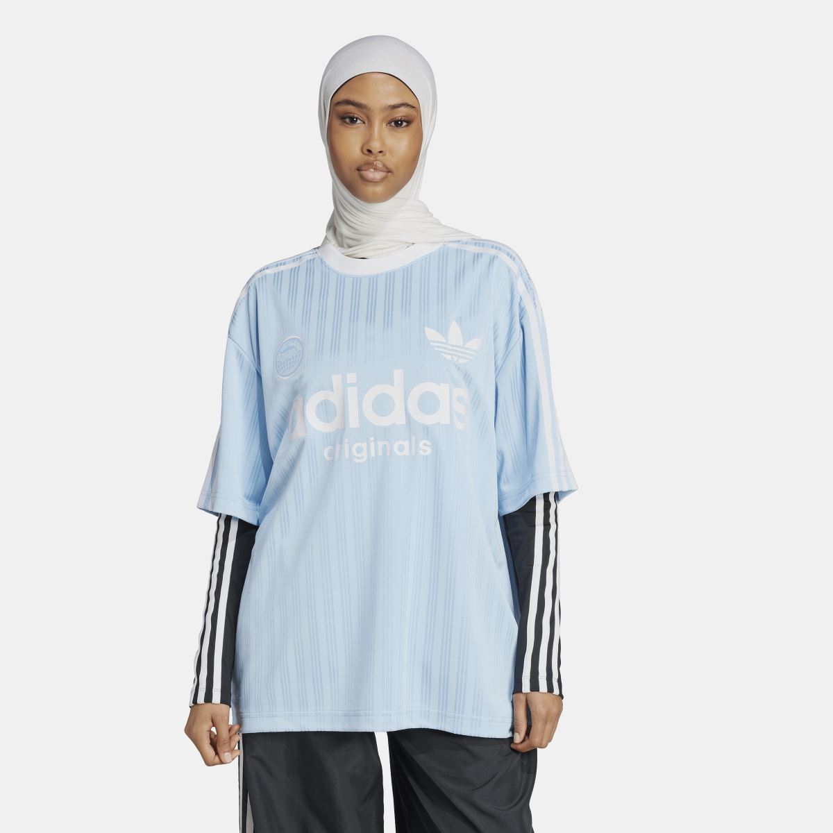 Light blue oversized t-shirt with vertical stripe pattern, front adidas Originals and trefoil.