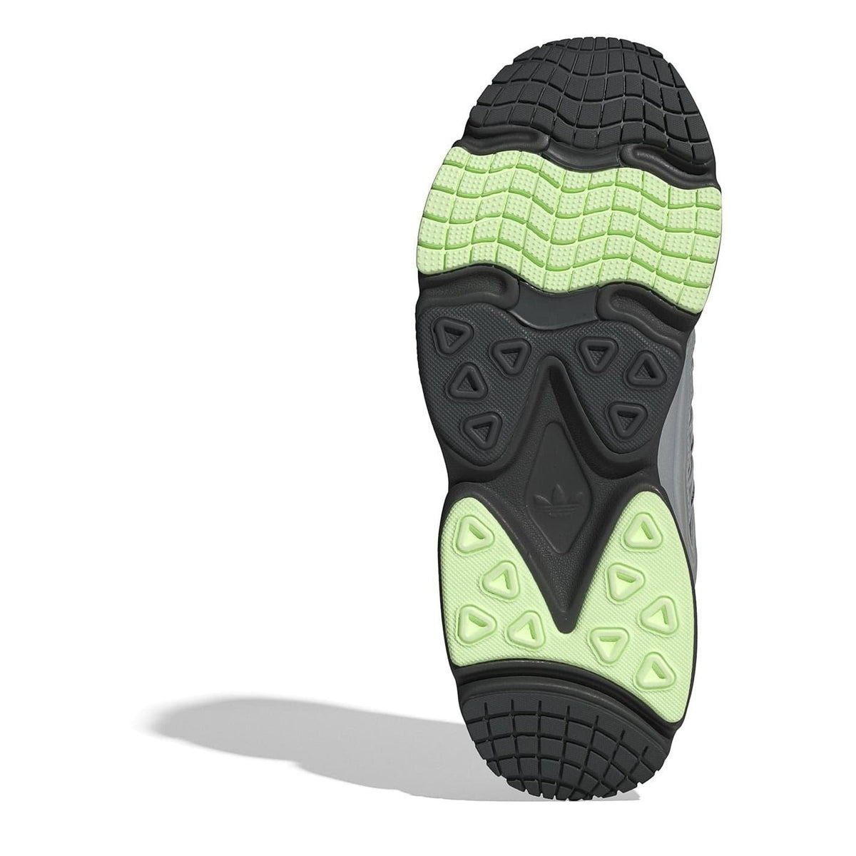 Shoe outsole with textured black tread and bright green traction zones