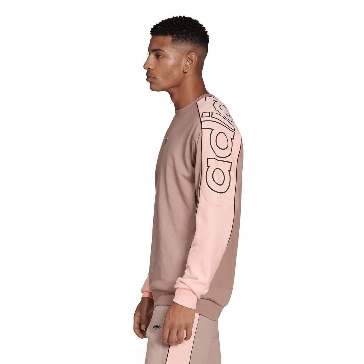 Side view relaxed crewneck sweatshirt in chalky brown with pink contrast panel and sleeve adidas graphic