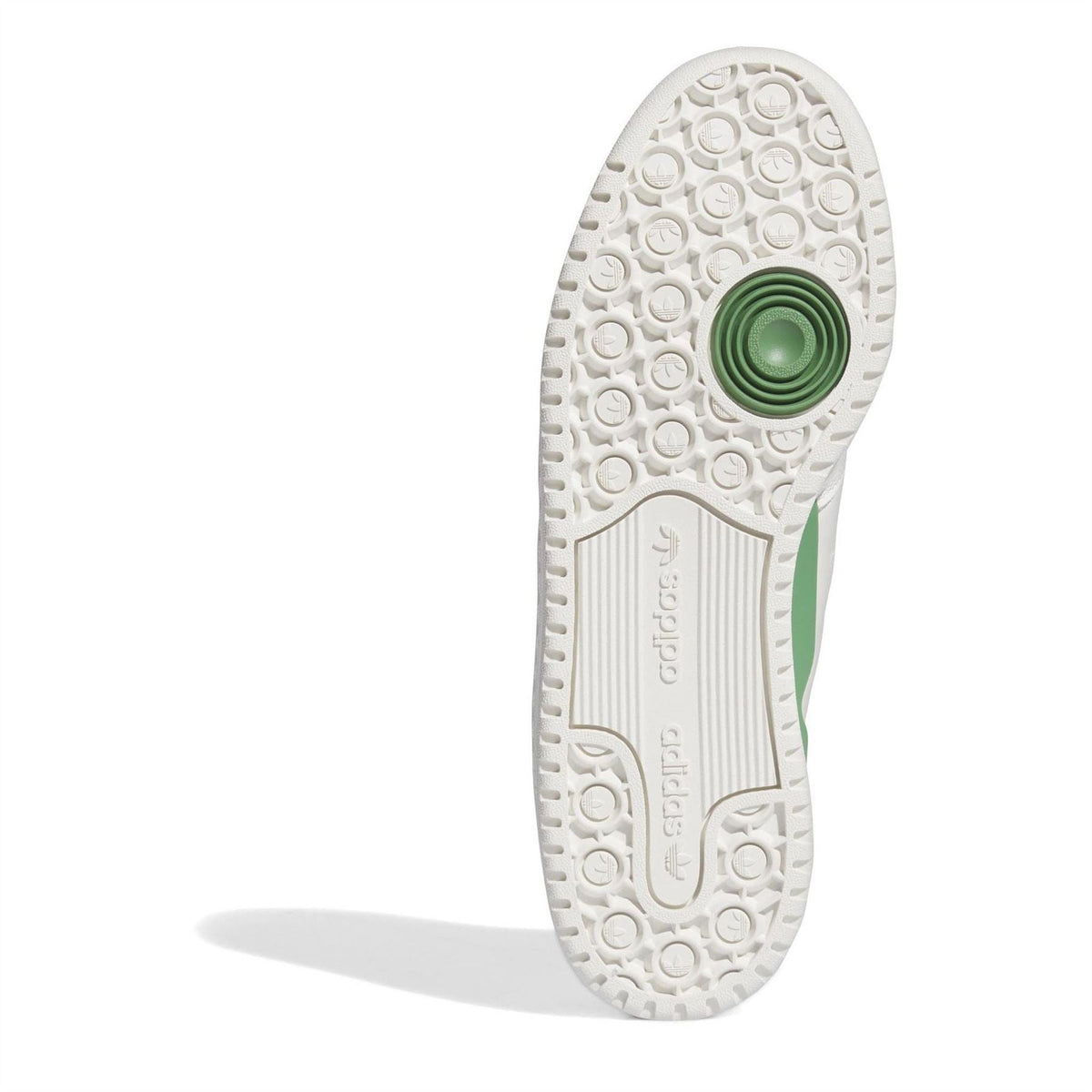 Outsole view of adidas Originals low-top sneakers with circular tread and green heel