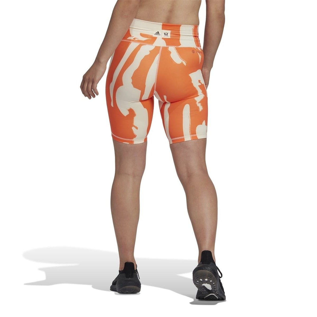 Orange and beige graphic biking shorts with elastic waistband and snug fit