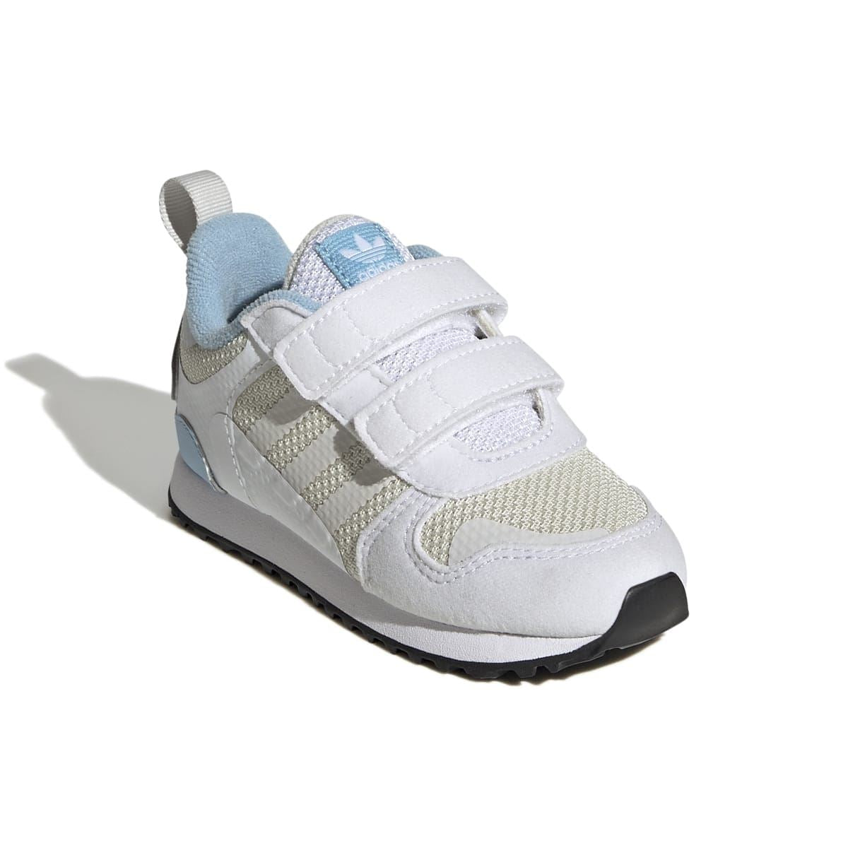 Infant side view of white and light-blue trainers with padded collar and textured mesh panels