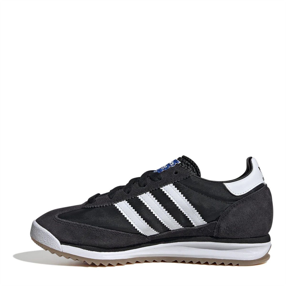 Black suede low-top sneakers with white triple stripes, lace-up front, gum outsole