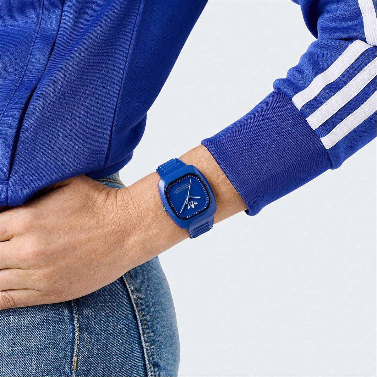 Blue adidas analog watch worn on wrist, silicone strap with square face and hands