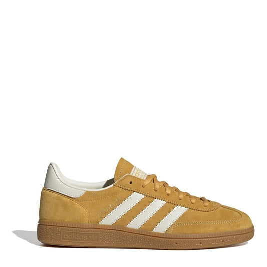 Tan suede low top sneakers with three white adidas stripes and lace-up closure.