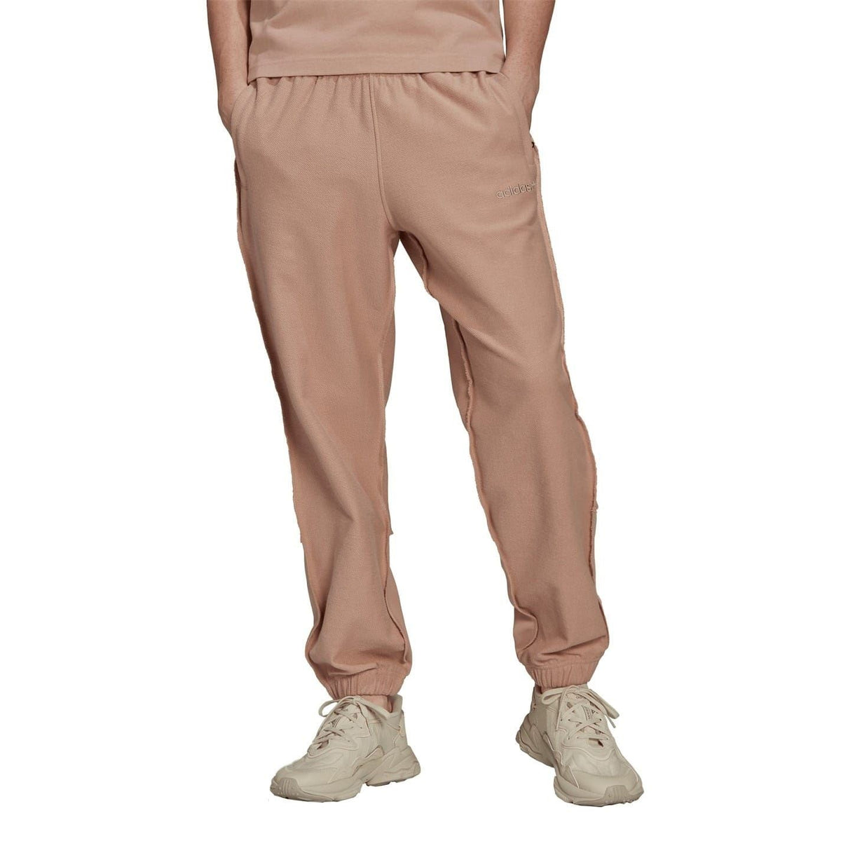Dusty pink tapered jogger pants with elastic ankle cuffs