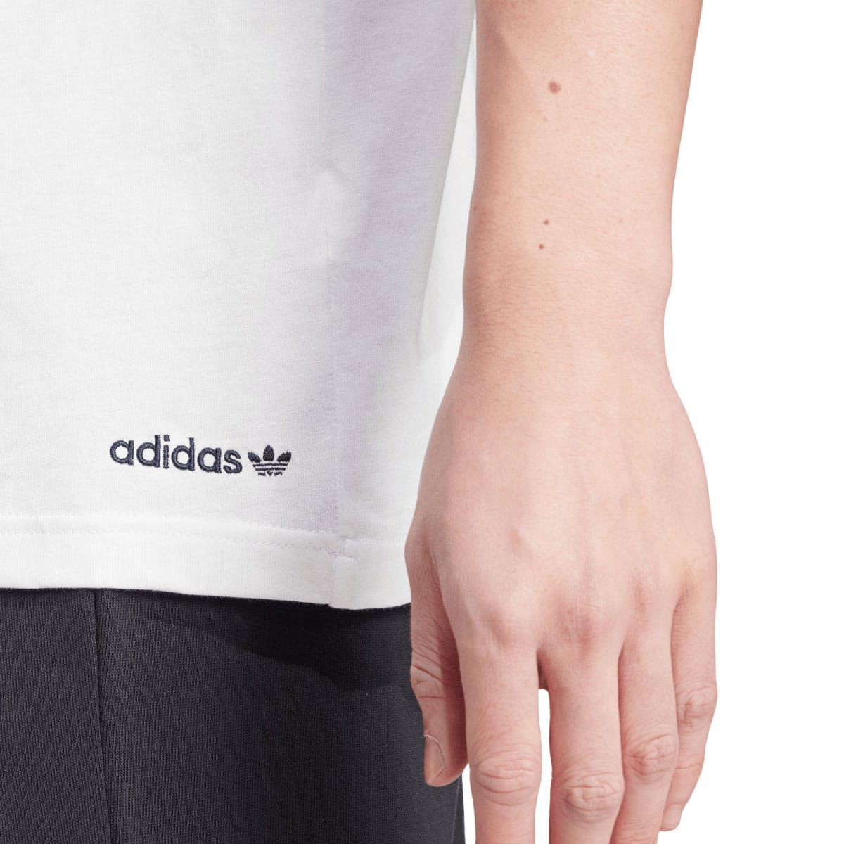 White T-shirt with adidas trefoil wordmark on the lower hem