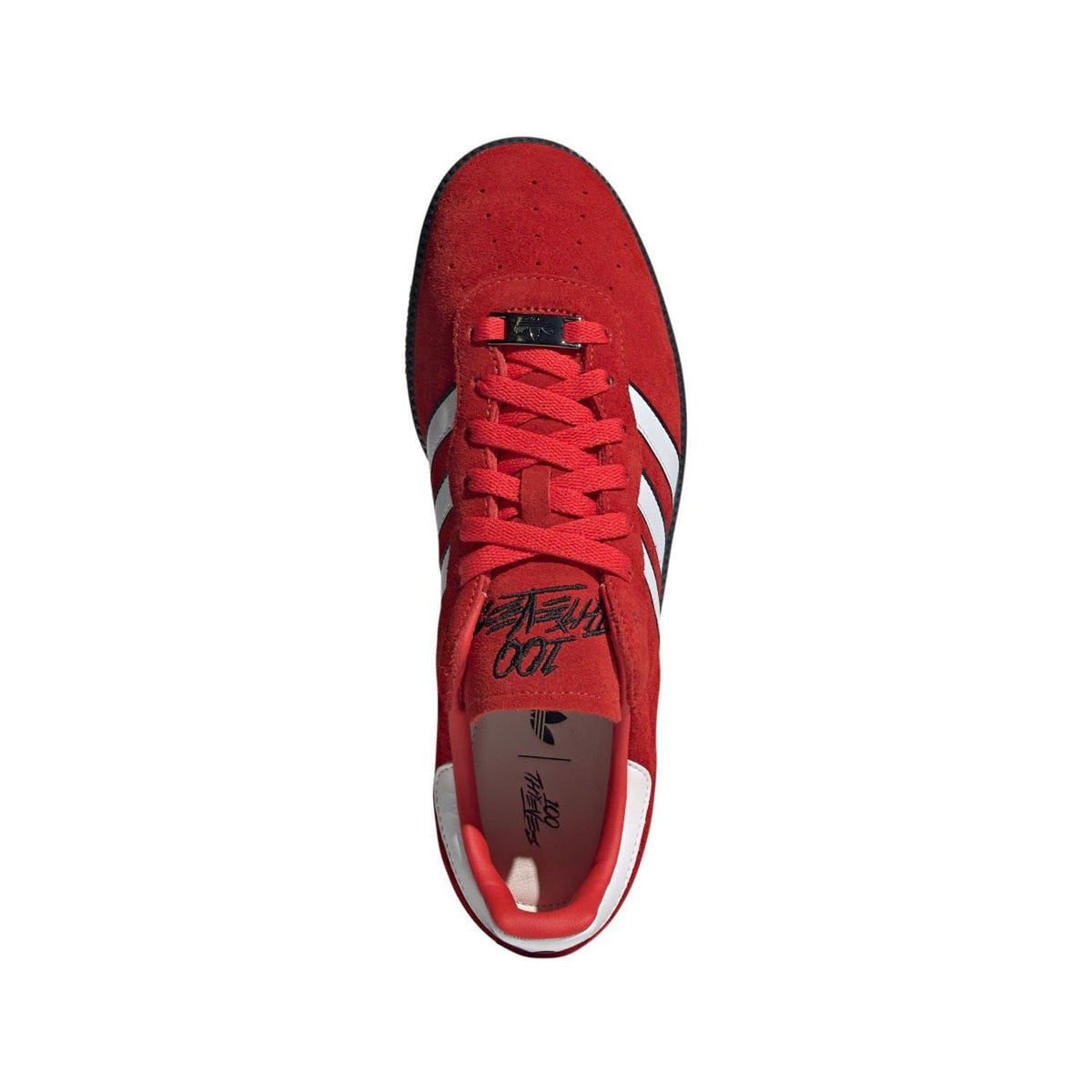 Red suede sneaker top view with lace-up ties and white side stripe accents