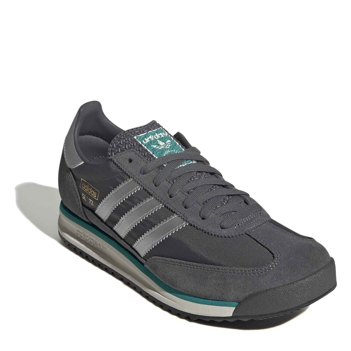 Dark grey low-top sneakers with white three stripes and teal outsole trim.