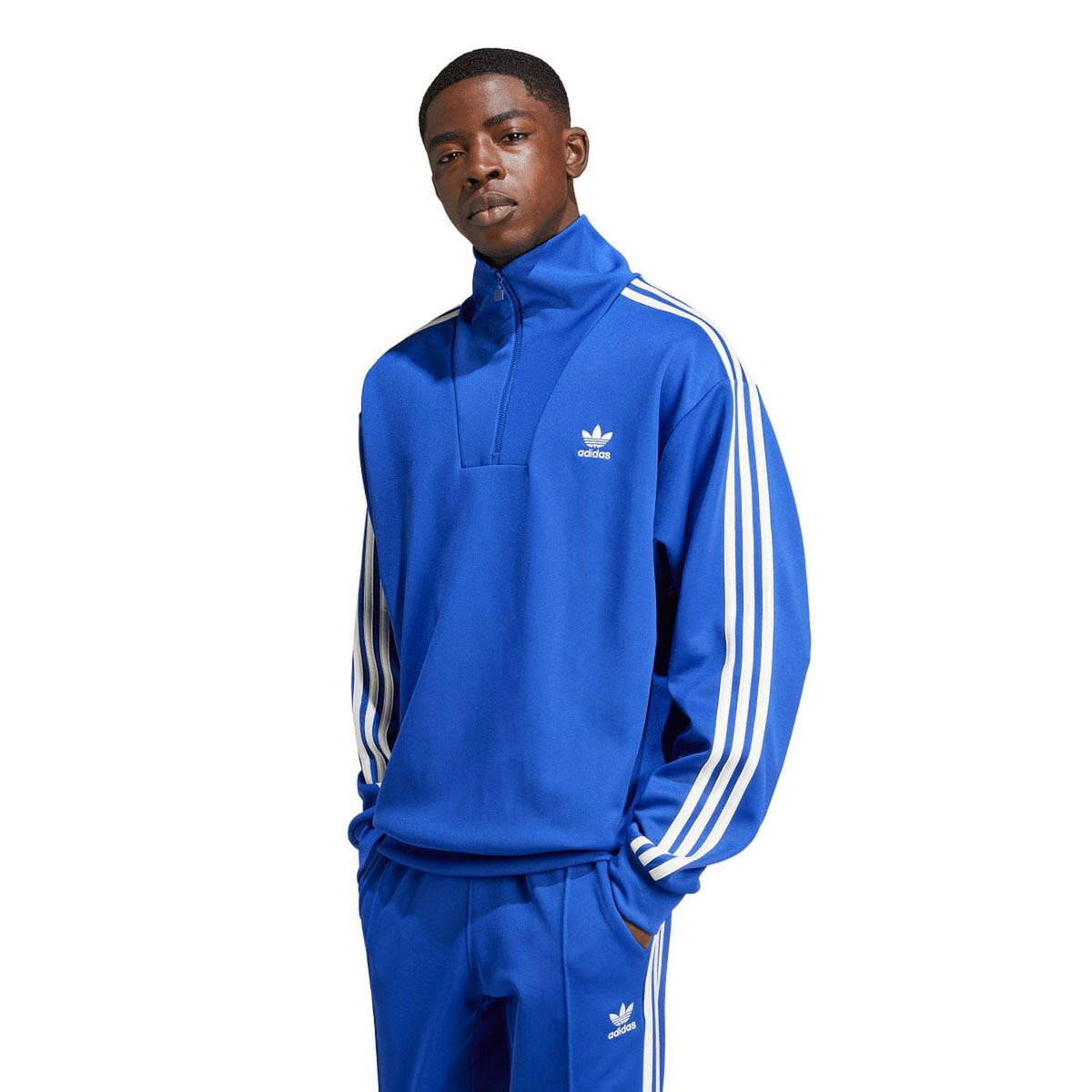 Blue adidas track top with funnel neck zip, white sleeve stripes, front logo.