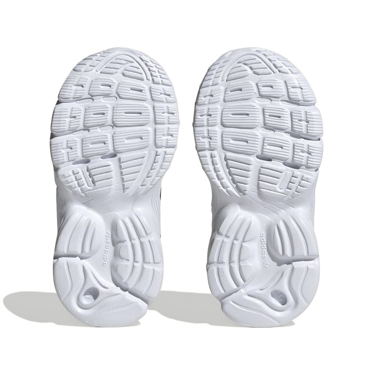 White outsole tread of trainers with deep rubber pattern and flex grooves