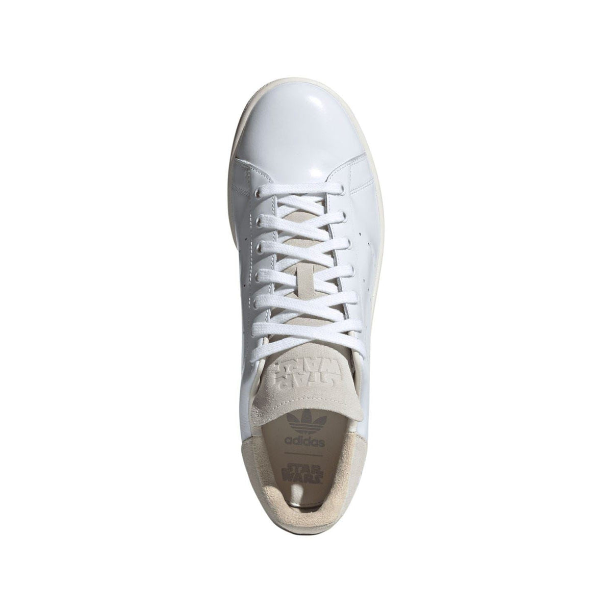 White adidas trainers viewed from the toe, with lace-up front and beige interior lining