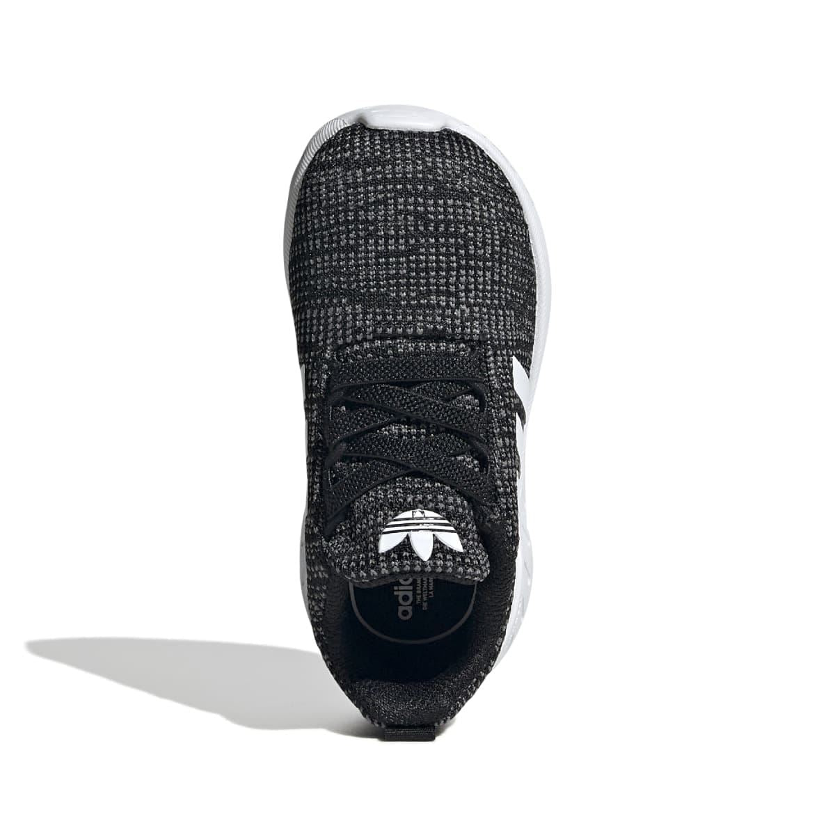 Infant trainer shoe with black textured upper, lace-up front, and white interior collar lining