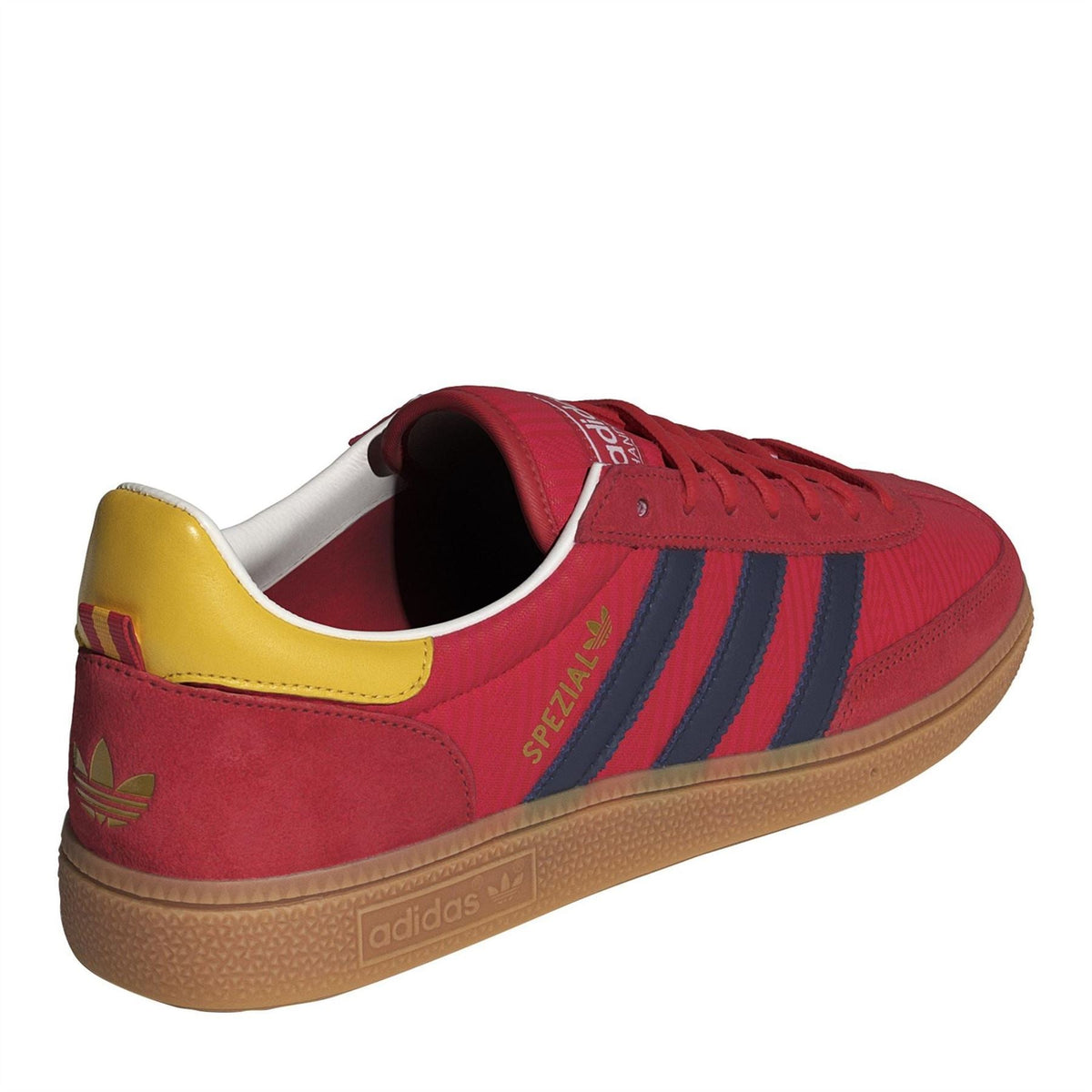 Red low-top trainers with navy stripes, yellow heel collar and gum rubber outsole