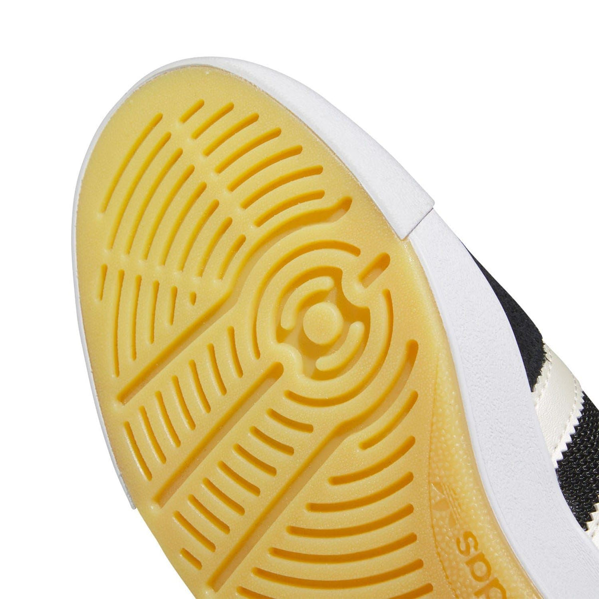 Close-up of yellow traction tread on the white trainer outsole
