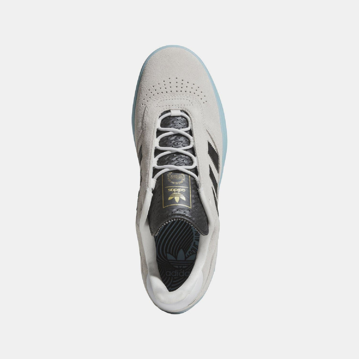 White lace-up trainer with perforated toe, adidas tongue label, and blue heel.