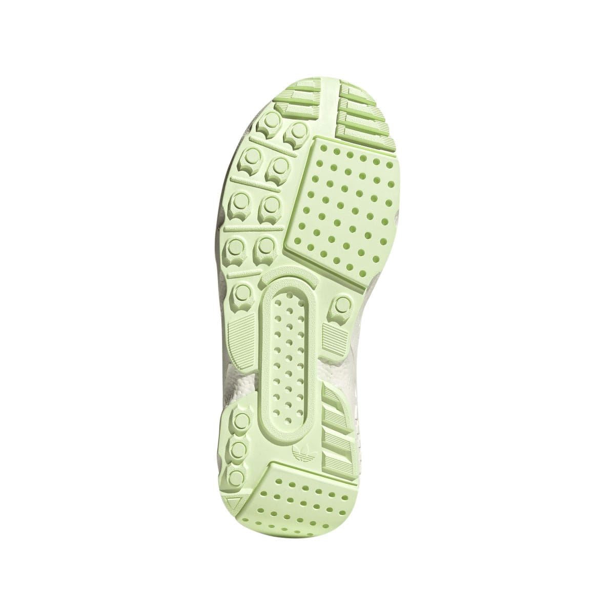 Green rubber outsole with textured traction pods and concentric tread pattern