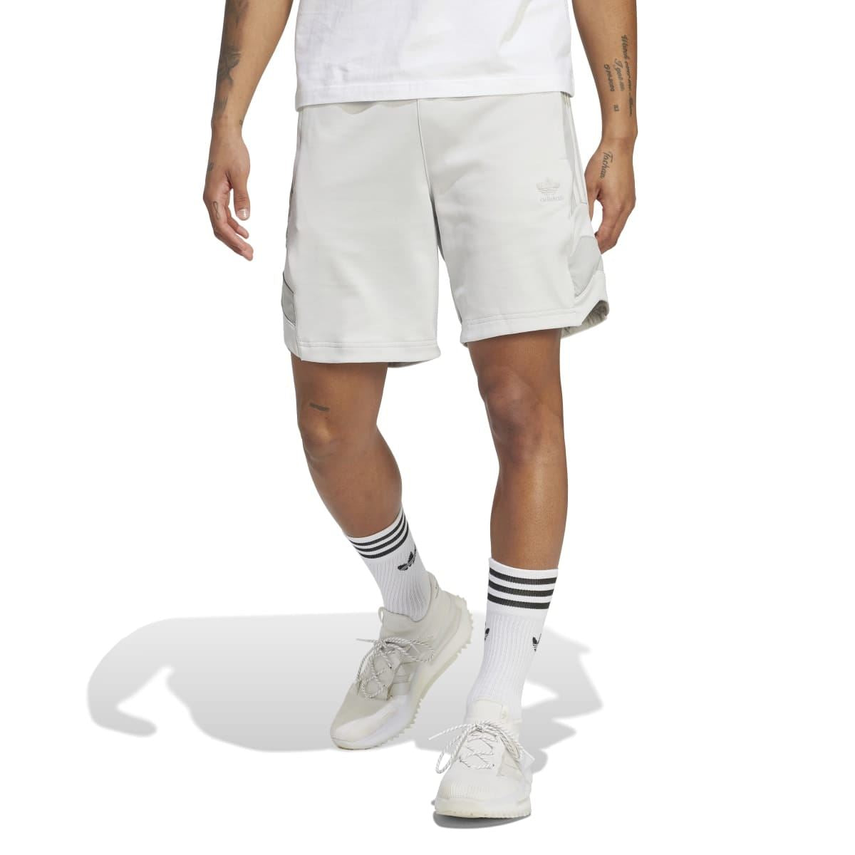 Light grey athletic shorts on model with visible elastic waistband and front pocket seams