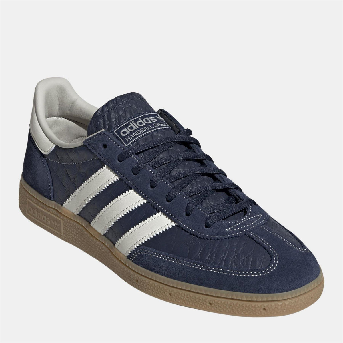 Navy adidas Spezial sneakers with white stripes and gum sole, lace-up.