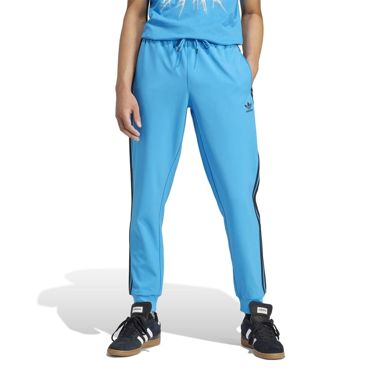 Blue slim track pants with side stripes, elastic waist and tapered ankle cuffs