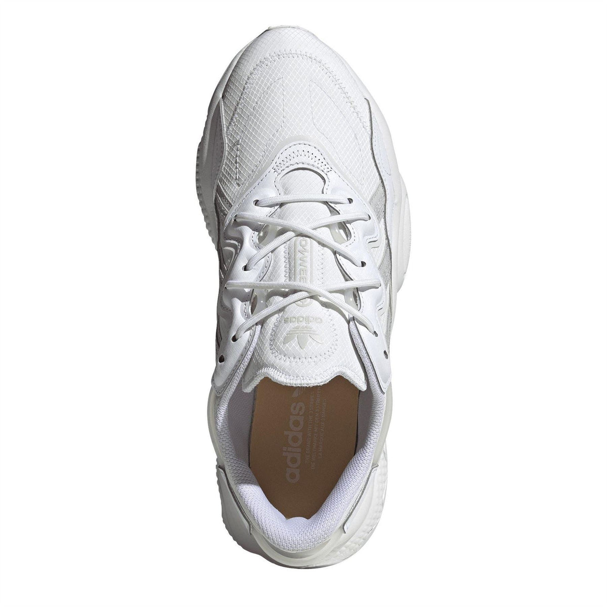 adidas Originals Ozweego low-top trainers in white with mesh and synthetic overlays, showcasing sporty sneaker design.