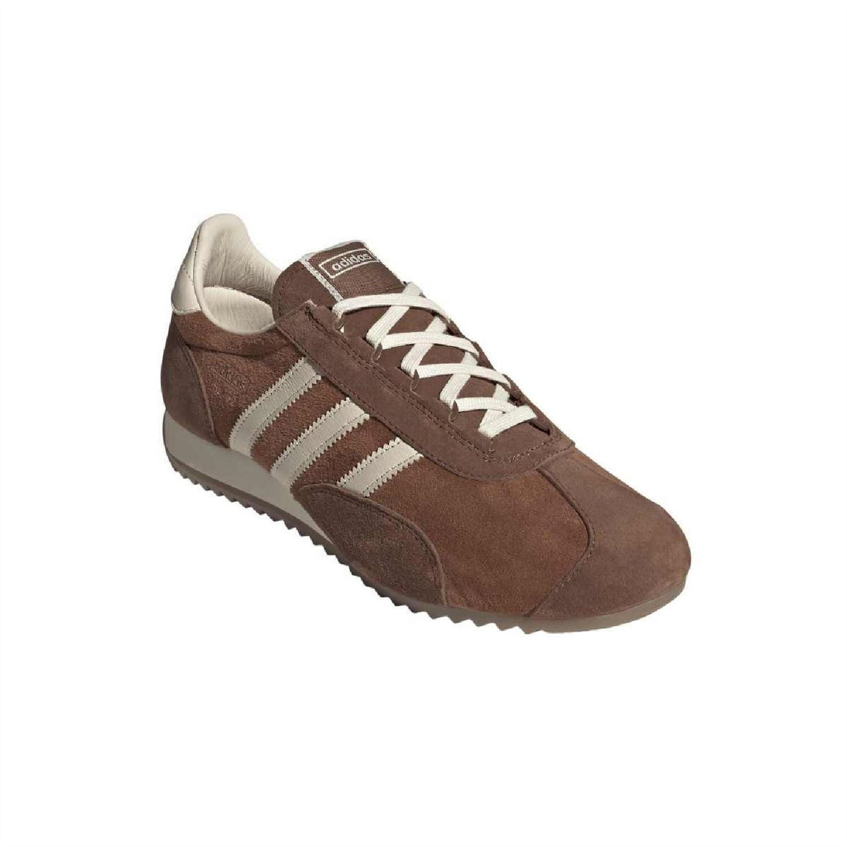 Brown suede trainers front with beige lining, white triple stripes, lace-up.