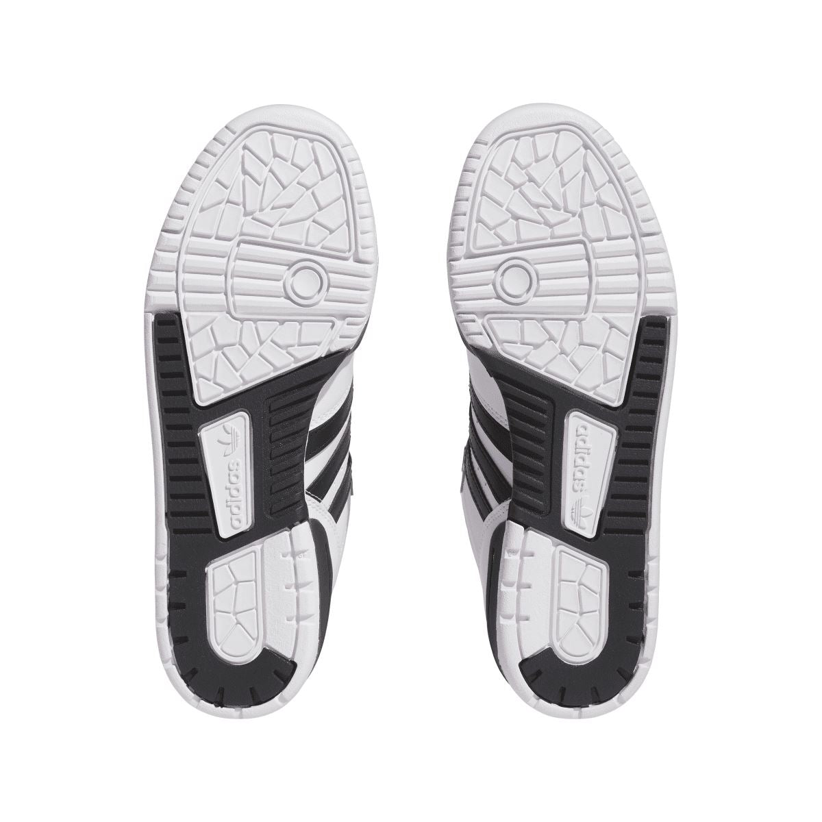 White low-top trainers outsole view with grippy tread and black heel accents