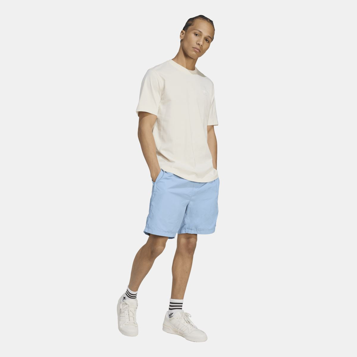 Light blue adidas Originals woven shorts on model, elastic waistband and side pockets
