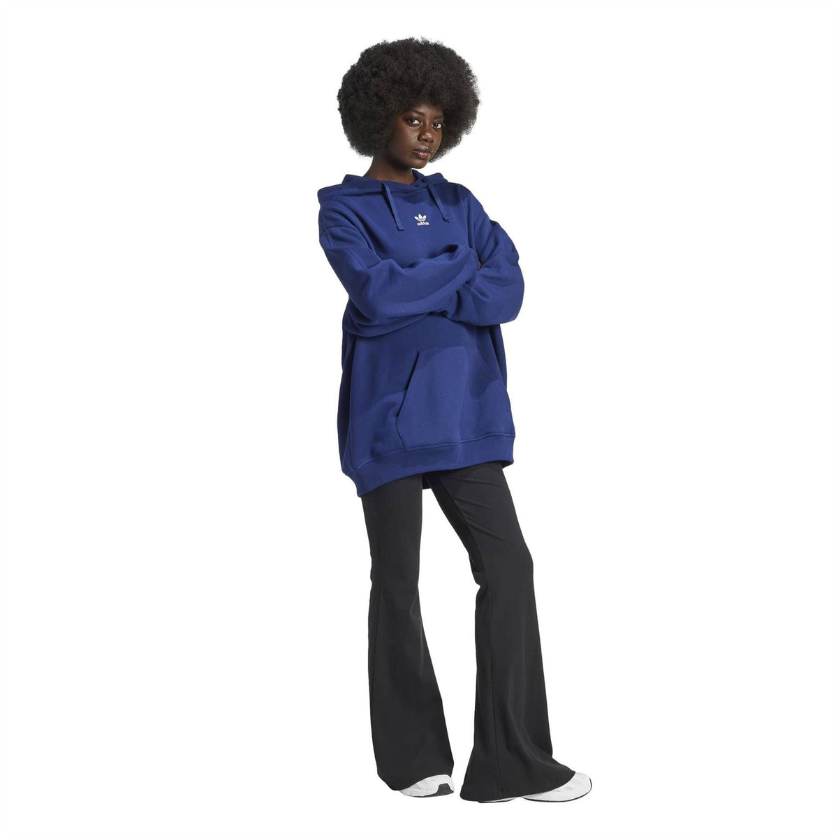 Dark blue adidas hoodie worn on model with black pants and white sneakers