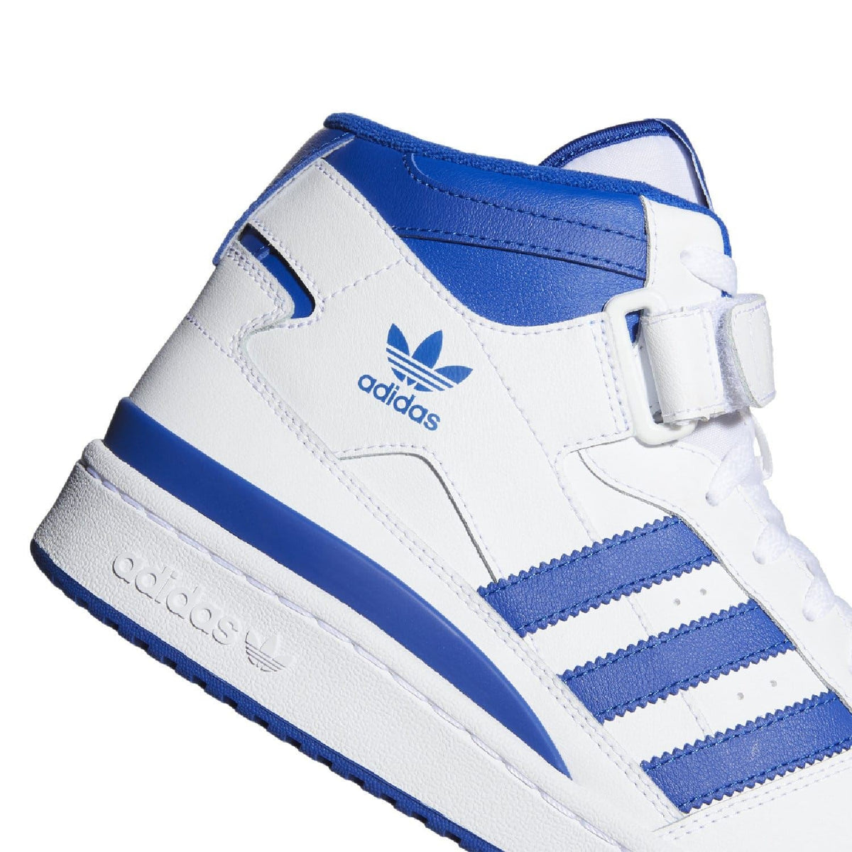 White and blue mid-top trainers close-up of upper, adidas logo and stripes