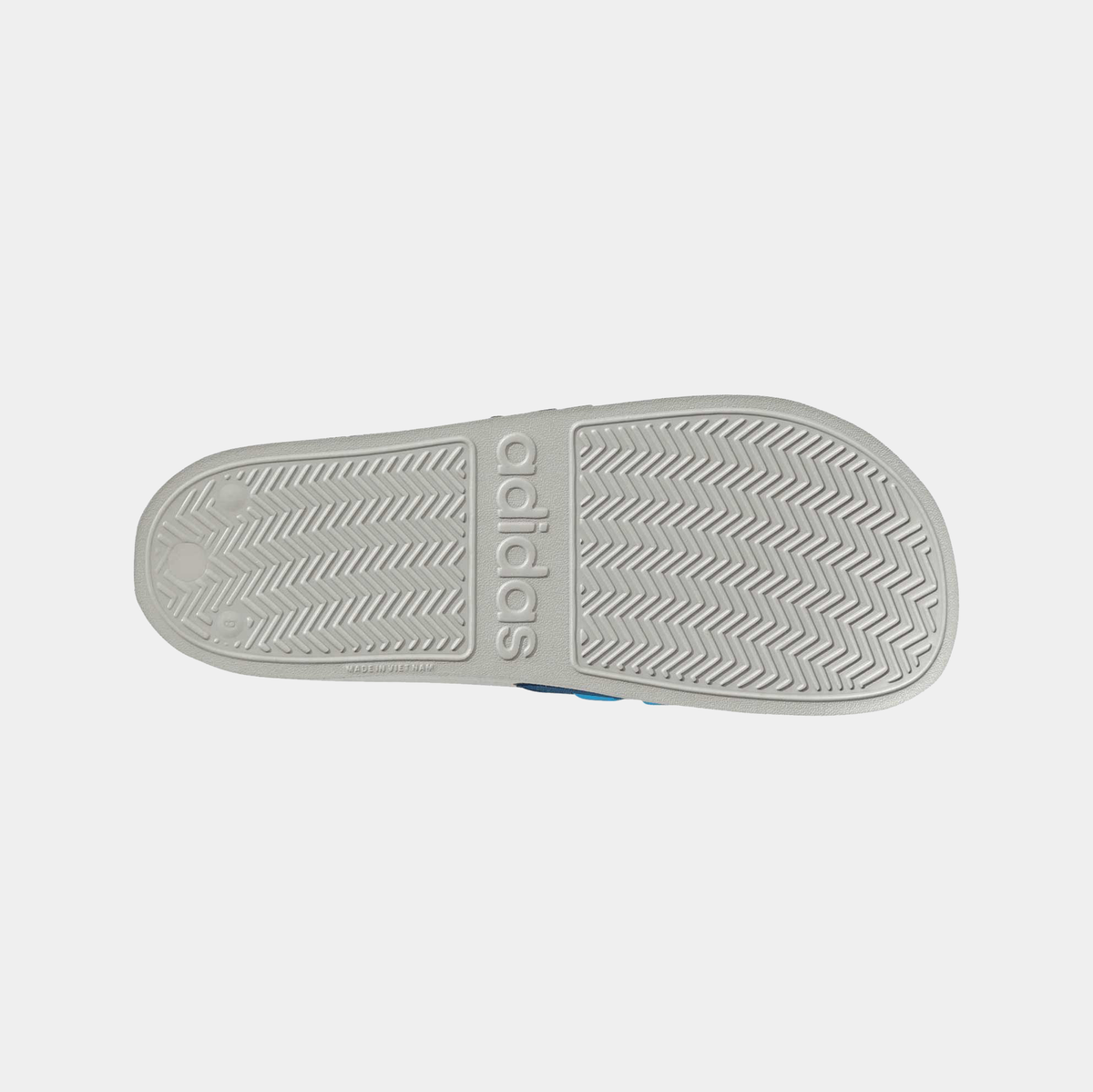 Adilette shower slides outsole view with textured pattern and adidas branding