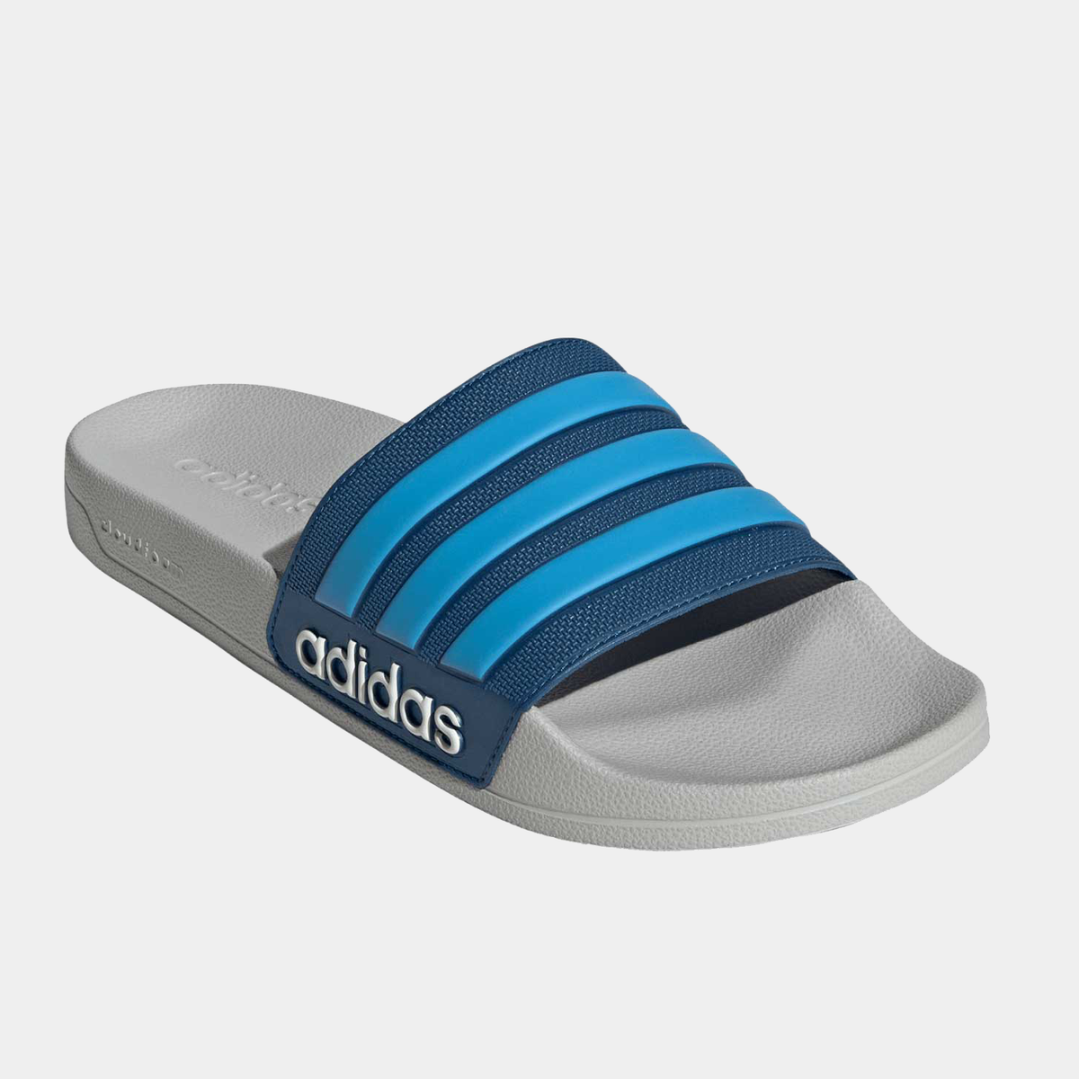 Adilette shower slides angled view with blue straps and adidas logo on footbed