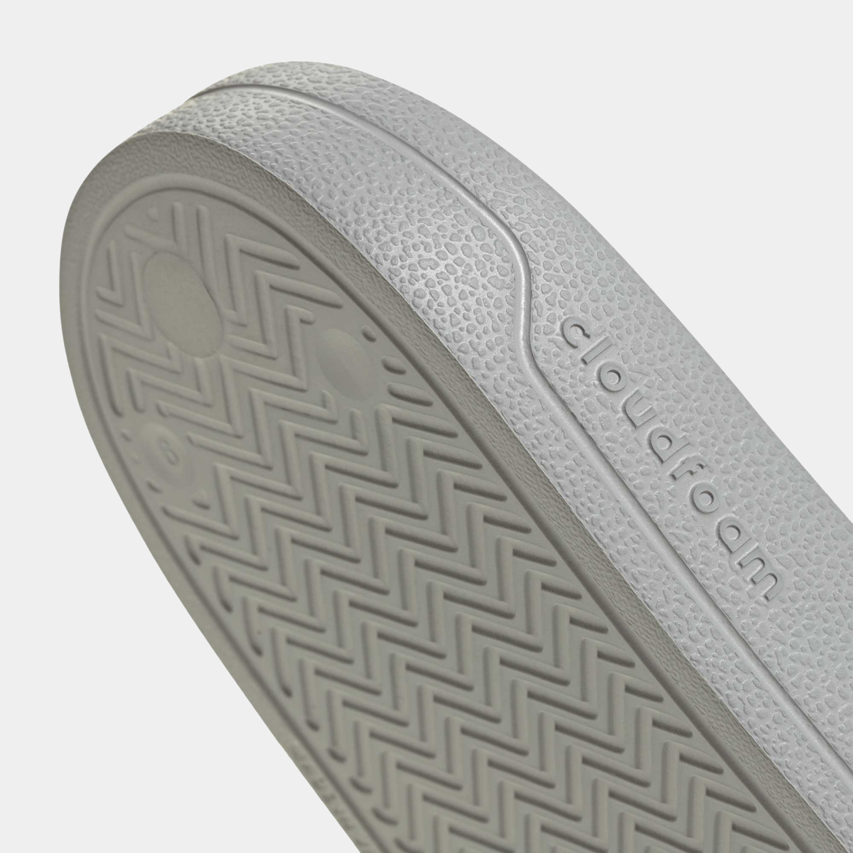 Adilette shower slides outsole detail with herringbone tread and adidas text