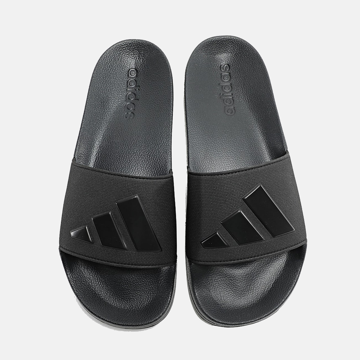 Black adidas shower slide sandals with 'adidas' branding on footbed