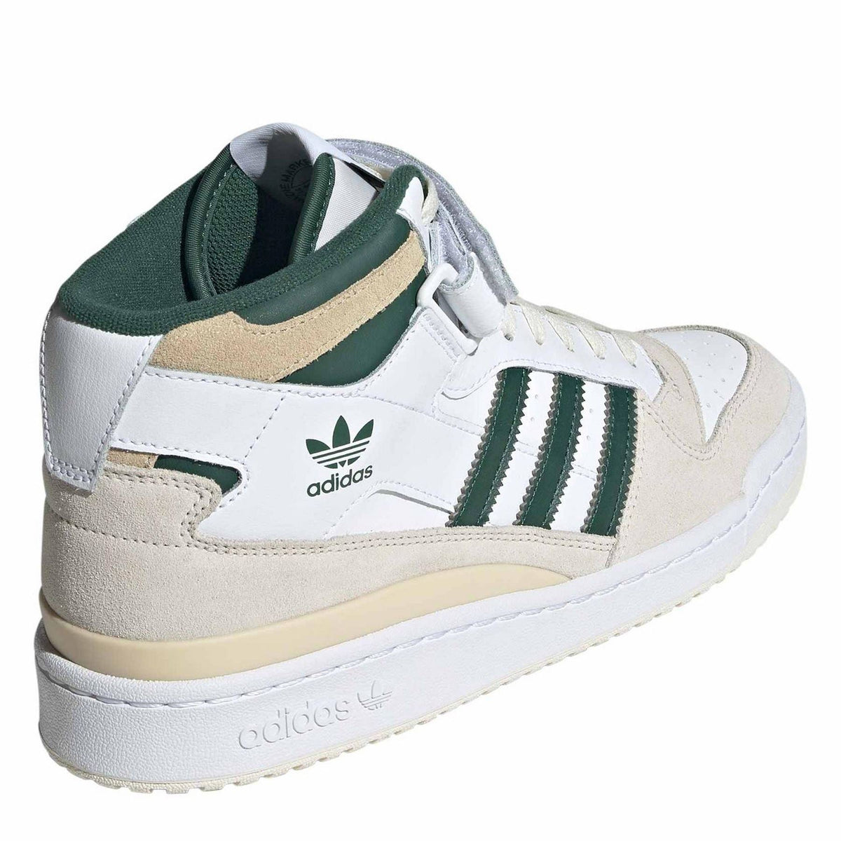 Mid-top sneakers with white leather, green heel lining, beige suede panels, side view