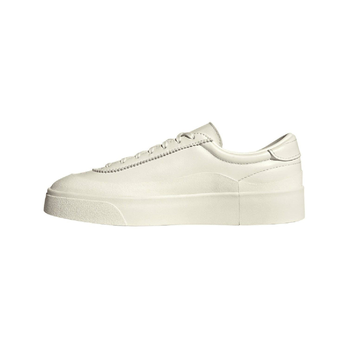 White low-top trainers with lace-up front, seam details, and thick platform sole.