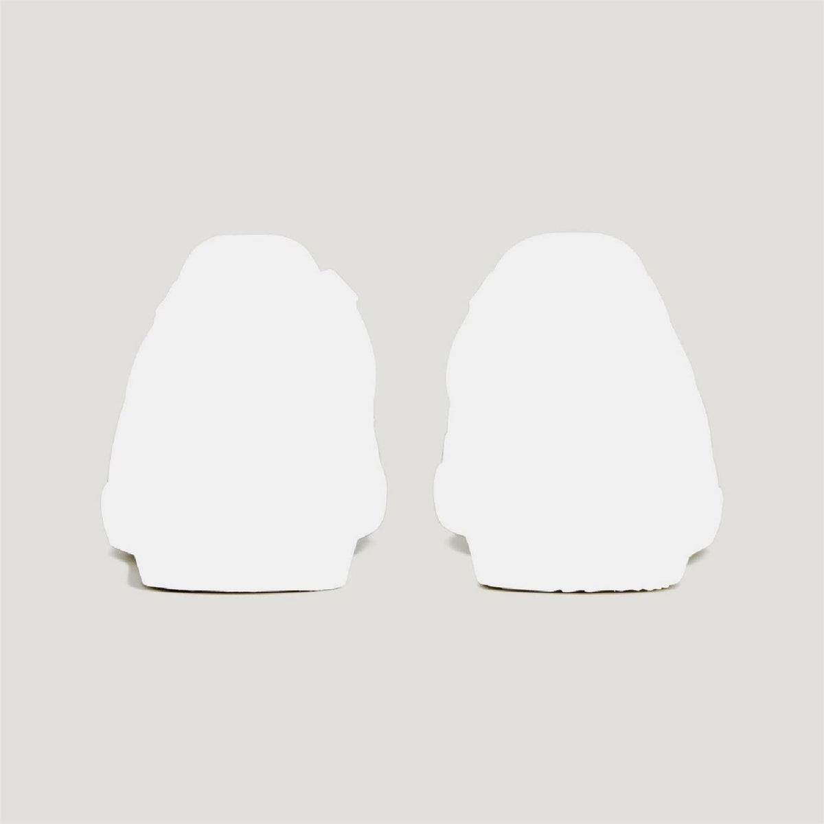 Pair of white sneaker heel backs with curved rubber sole