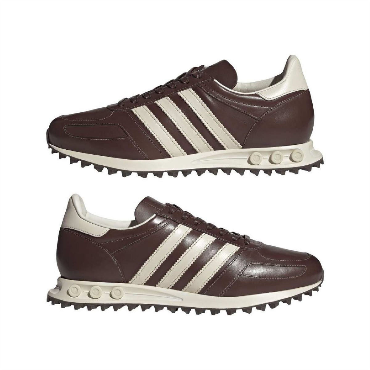 Pair of dark brown lace-up sneakers with three white stripes and off-white sole
