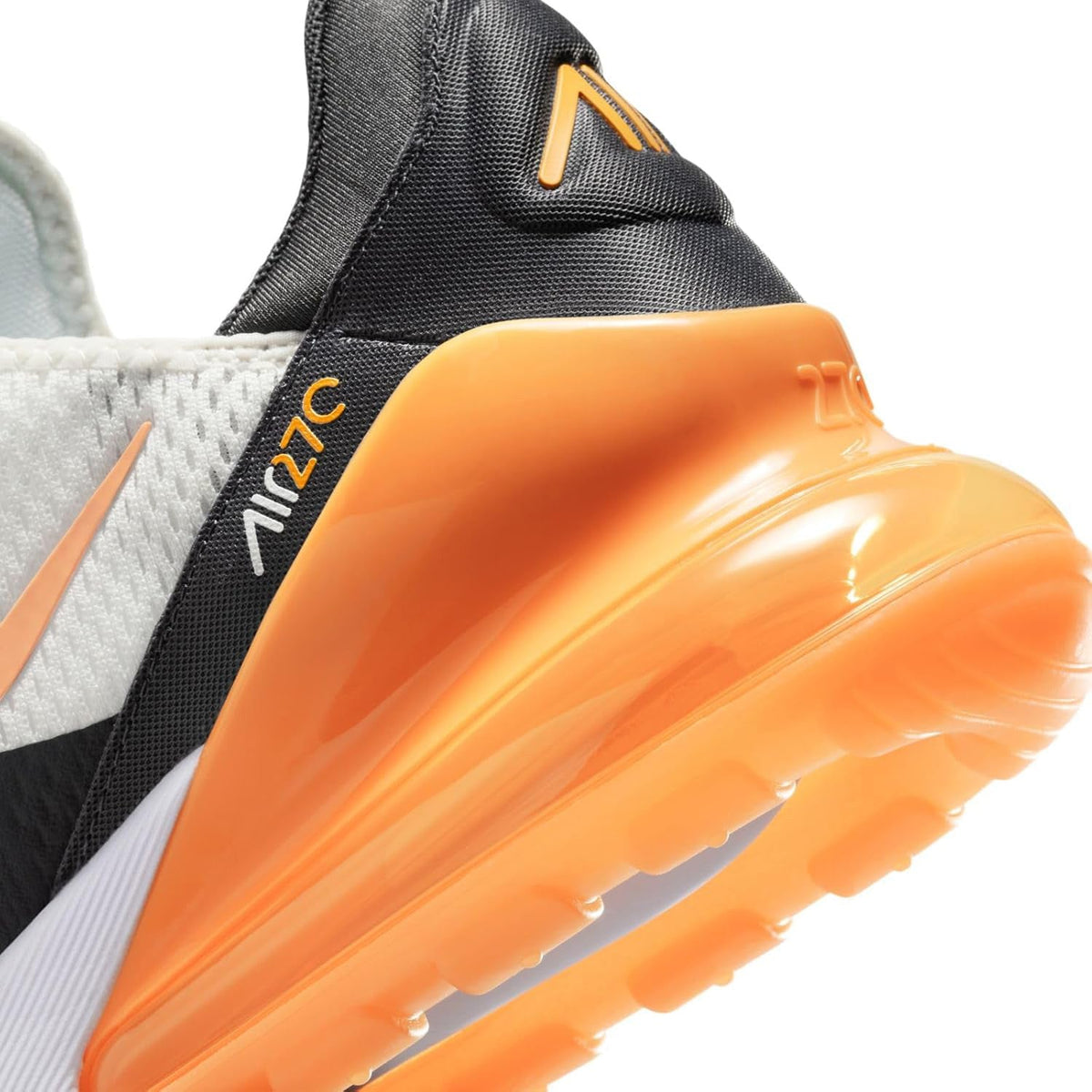 Nike Air Max 270 heel close-up with orange air unit, black collar, and orange swoosh accents.