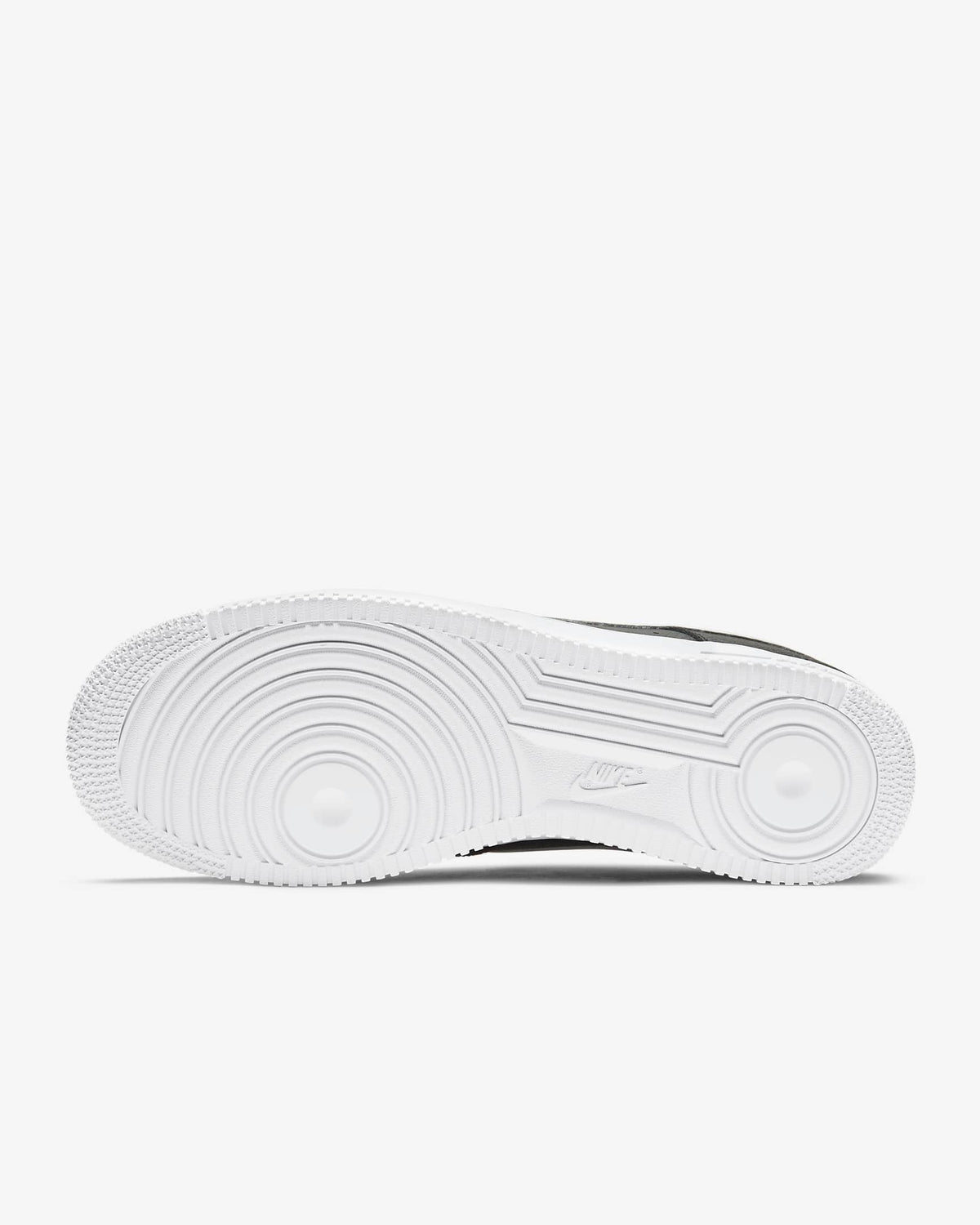 White rubber outsole with tread pattern under a black-and-white low-top sneaker