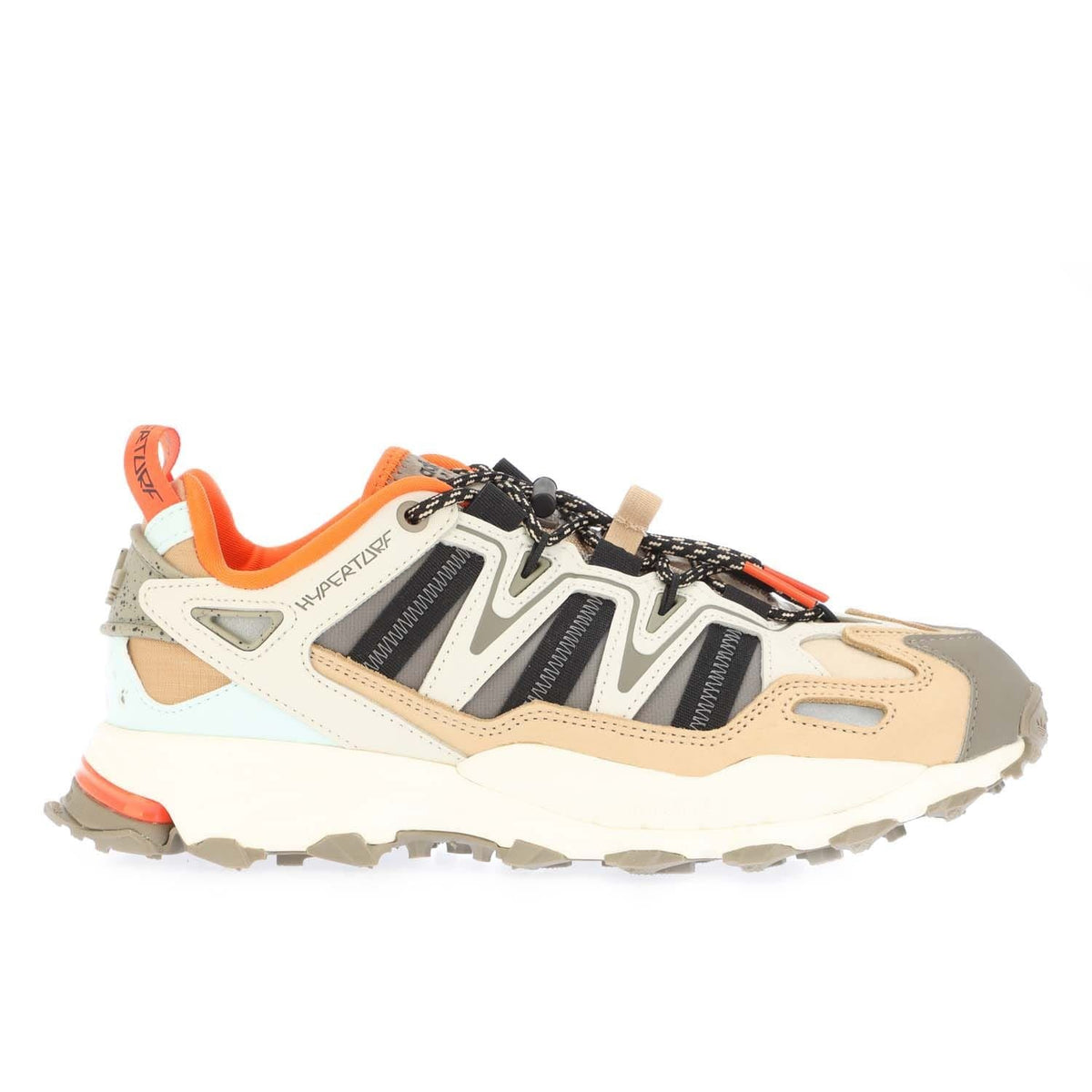 Grey and cream low-top trainers with black stripe panels, orange lining, and laces